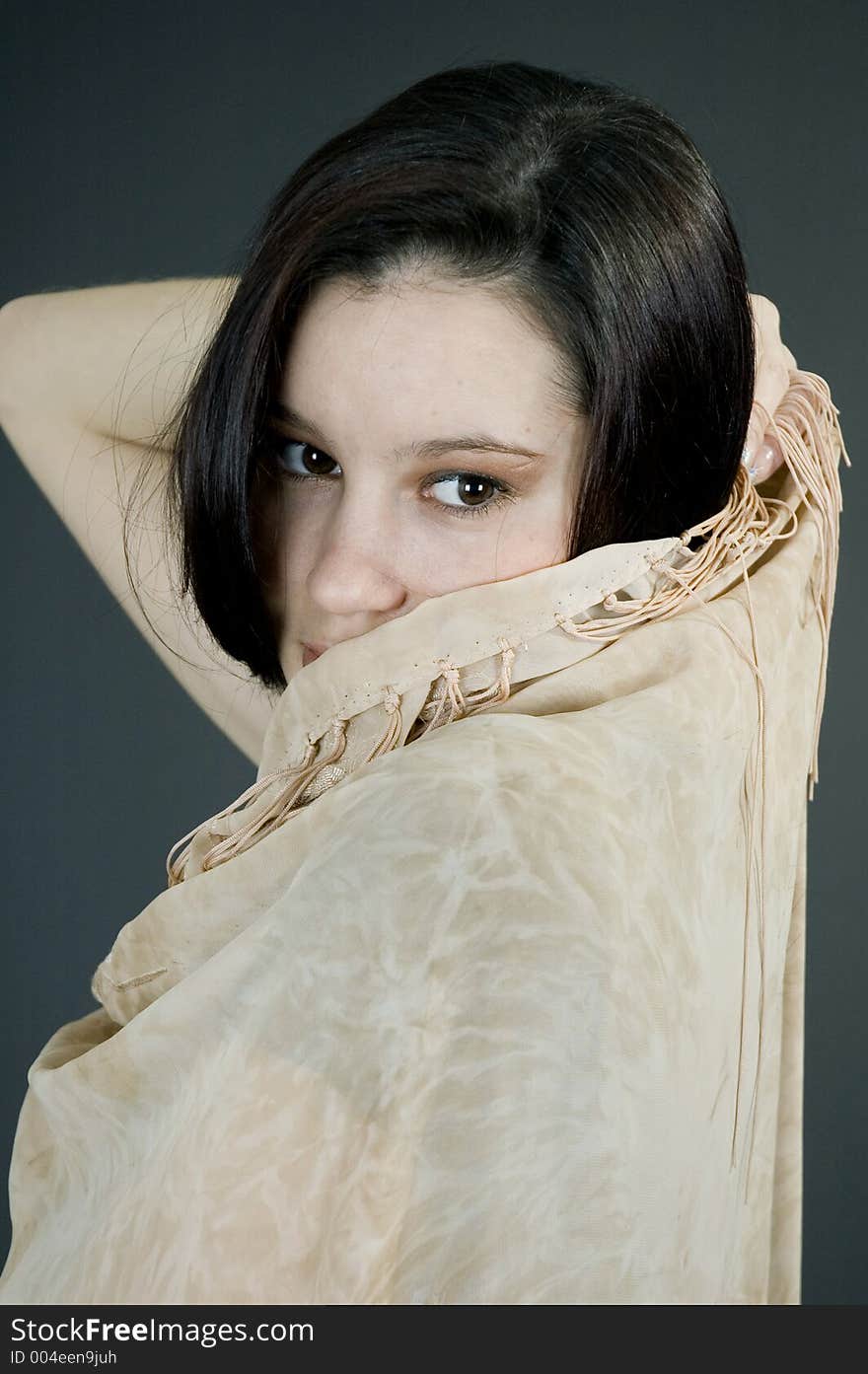 Hiding behind a beige scarf