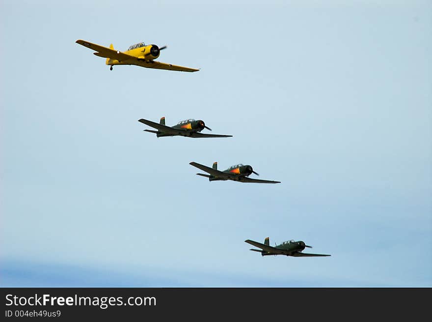 A Texan AT6 leads a group of Nanchang warplanes in group formation. A Texan AT6 leads a group of Nanchang warplanes in group formation.