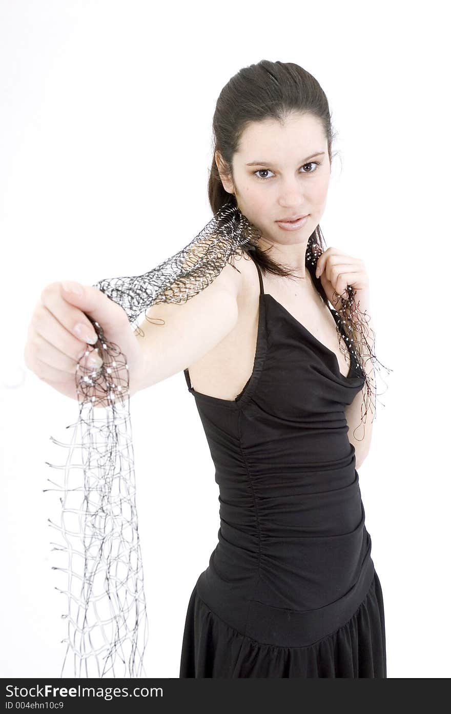 Pretty young brunette with a fresh, fit look, dressed in a short, light, black dress and playing with a net shawl over a white studio background, performs various postures and expressions. Pretty young brunette with a fresh, fit look, dressed in a short, light, black dress and playing with a net shawl over a white studio background, performs various postures and expressions