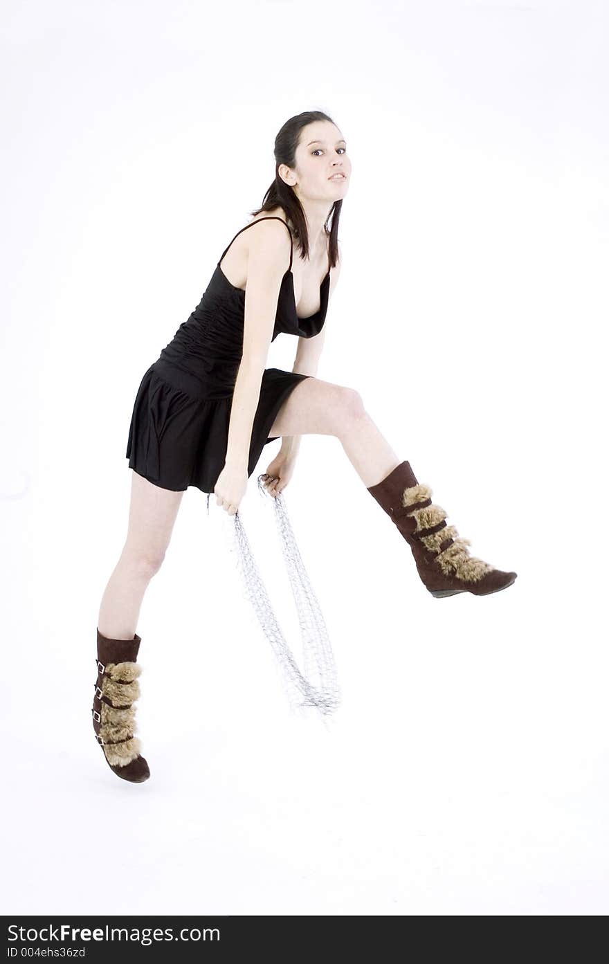 Pretty young brunette with a fresh, fit look, dressed in a short, light, black dress and playing with a net shawl over a white studio background, performs various postures and expressions. Pretty young brunette with a fresh, fit look, dressed in a short, light, black dress and playing with a net shawl over a white studio background, performs various postures and expressions