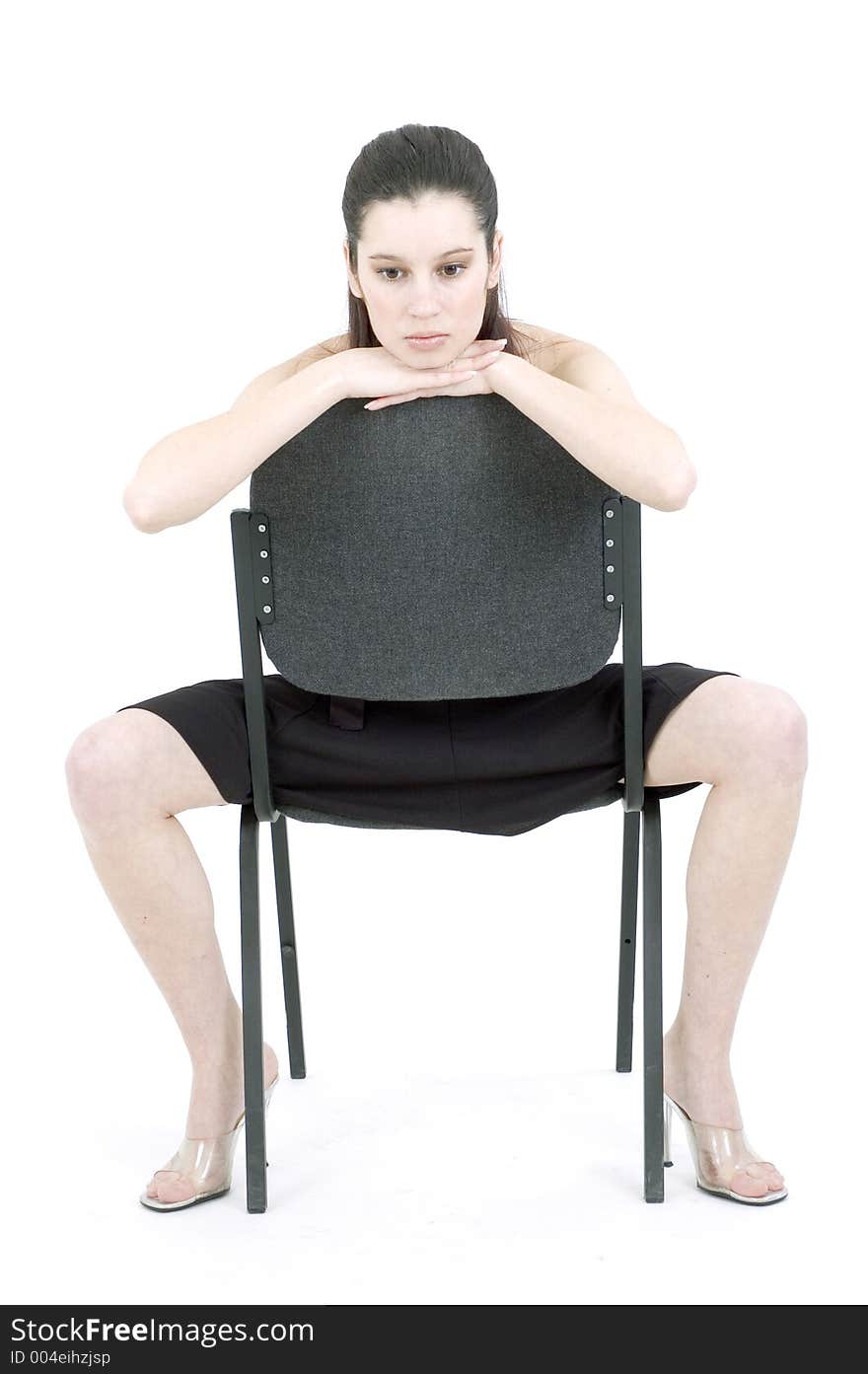 Young woman on a chair thinking. Young woman on a chair thinking