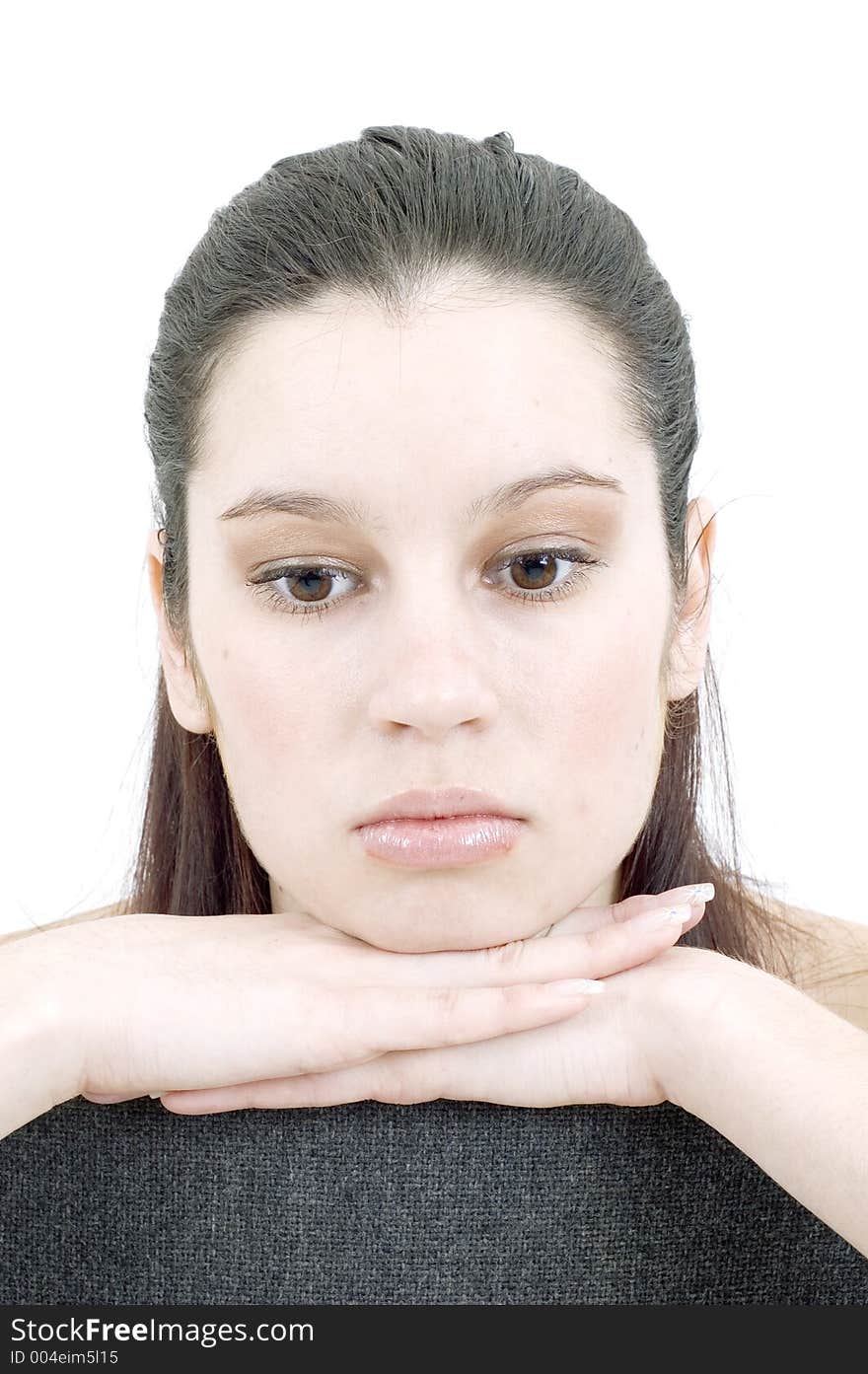 Deeply thoughtful beautiful girl, holding her hands under her chin, with a neat look and pure expression. Deeply thoughtful beautiful girl, holding her hands under her chin, with a neat look and pure expression