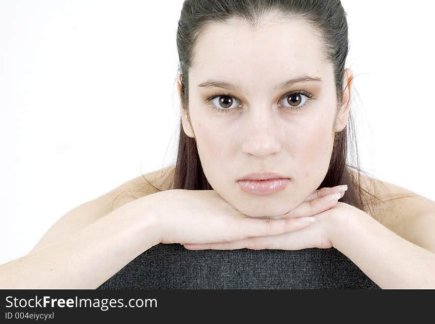 Deeply thoughtful beautiful girl, holding her hands under her chin, with a neat look and pure expression. Deeply thoughtful beautiful girl, holding her hands under her chin, with a neat look and pure expression