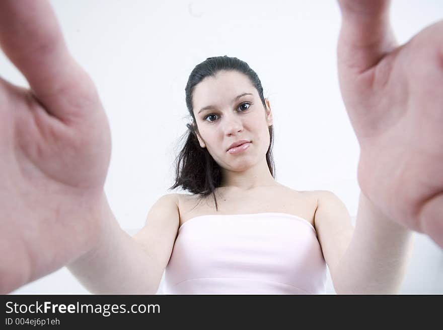 Beautiful young model looks at the camera from above, lifting it with her hands. Beautiful young model looks at the camera from above, lifting it with her hands