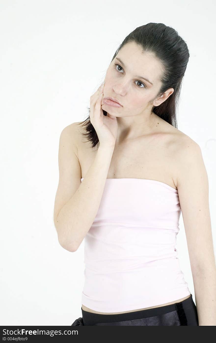 Portrait of a beautiful, young woman, checking her perfect face skin with a serious expression. Portrait of a beautiful, young woman, checking her perfect face skin with a serious expression