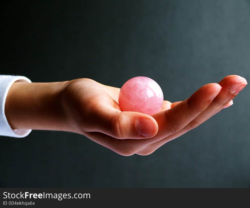 Hand and pink stone sphere. Hand and pink stone sphere