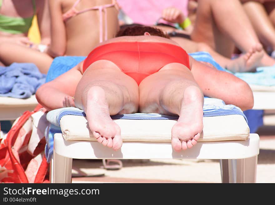 Adult woman on a deckchair having sunbathe