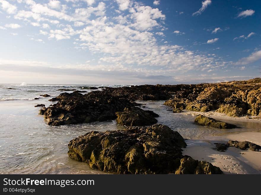 Rocks and tide pools on a sunny beach