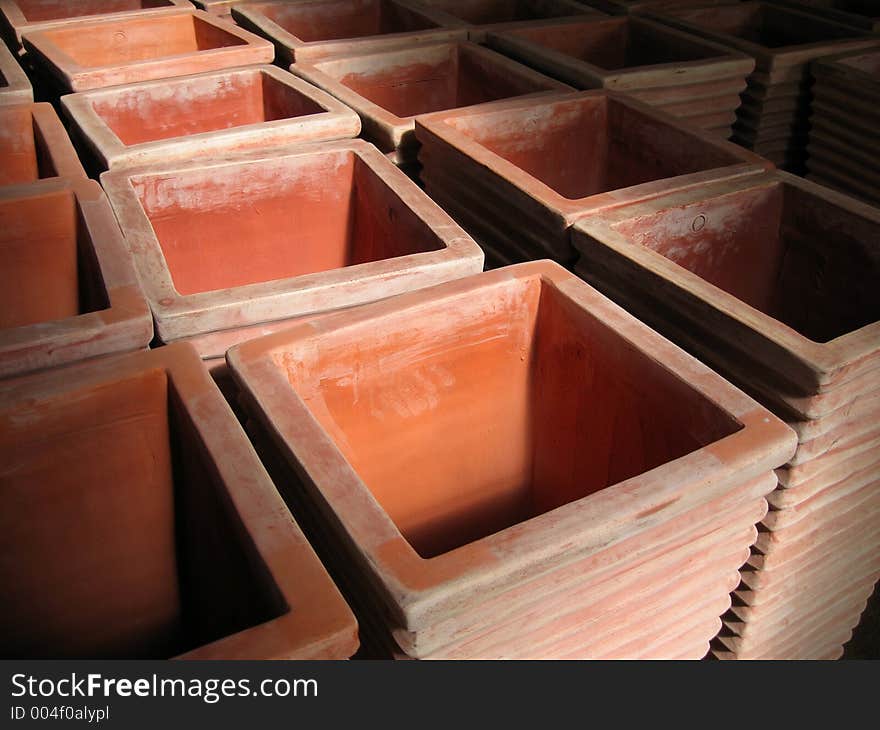 Rows of tall rectangular terracotta pots. Rows of tall rectangular terracotta pots.