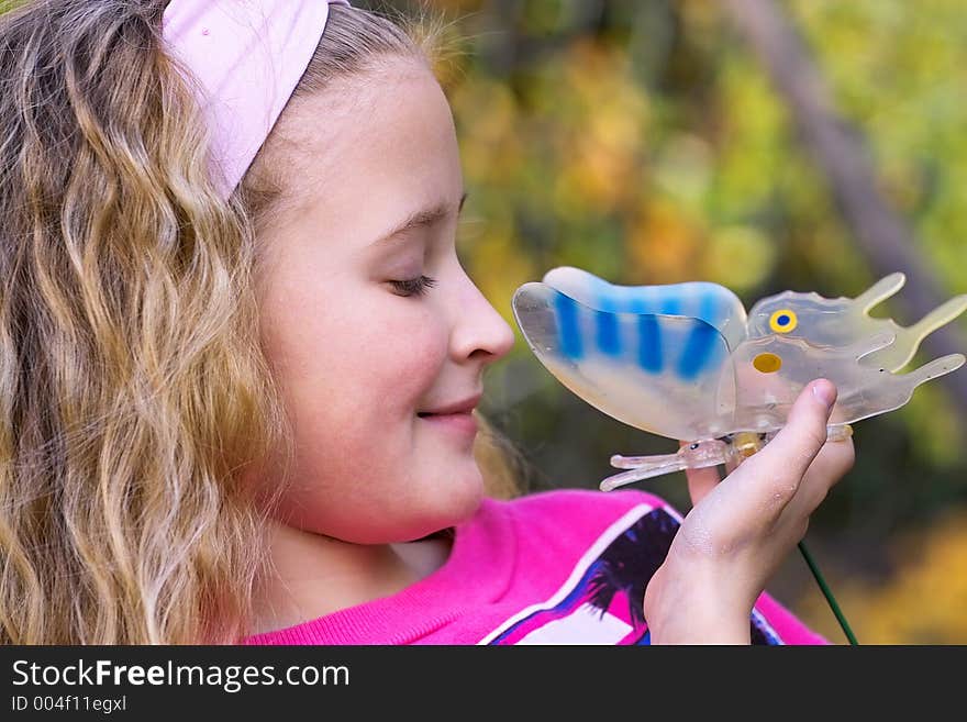 Portrait of a beautiful young girl outside in the garden with butterfly. Portrait of a beautiful young girl outside in the garden with butterfly