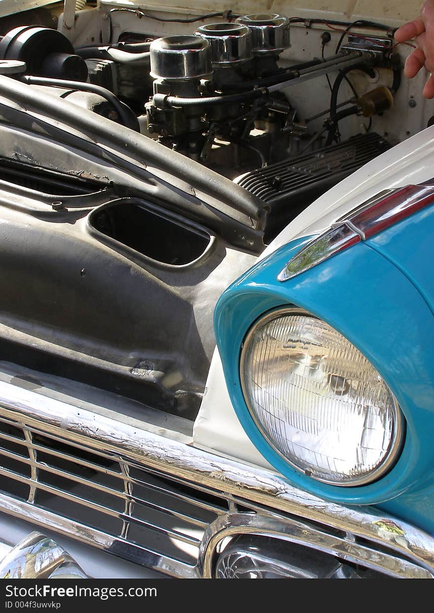 Checking out the engine of a vintage auto. Checking out the engine of a vintage auto