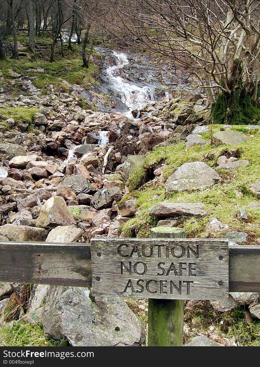 Stream running down a mountain side towards a lake. Stream running down a mountain side towards a lake