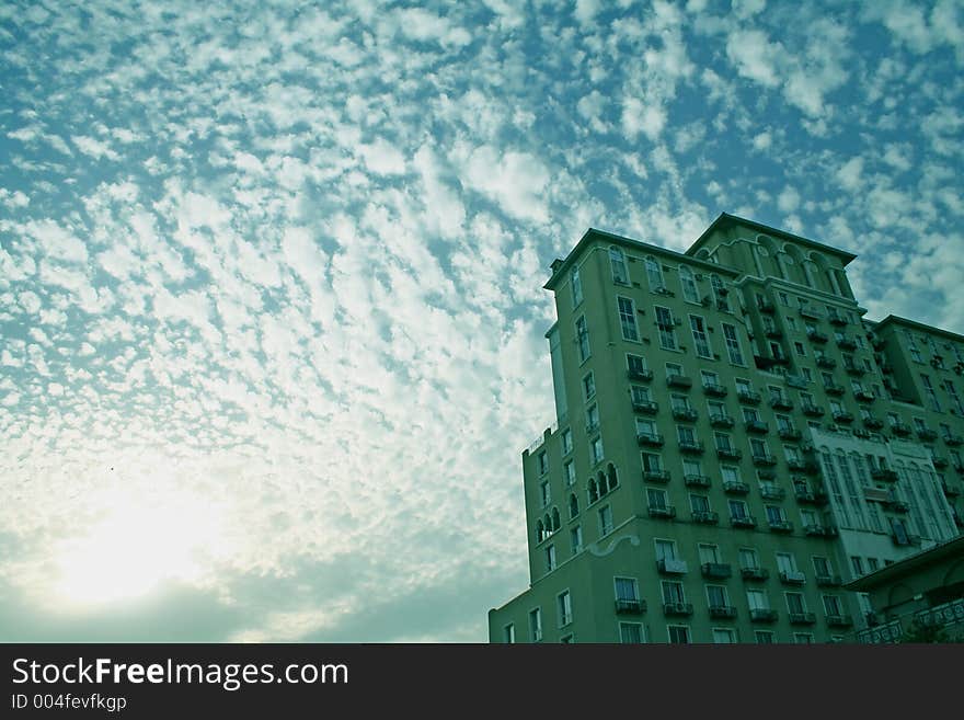 Silhouetted skyscraper wih patterned cloud formation. Silhouetted skyscraper wih patterned cloud formation