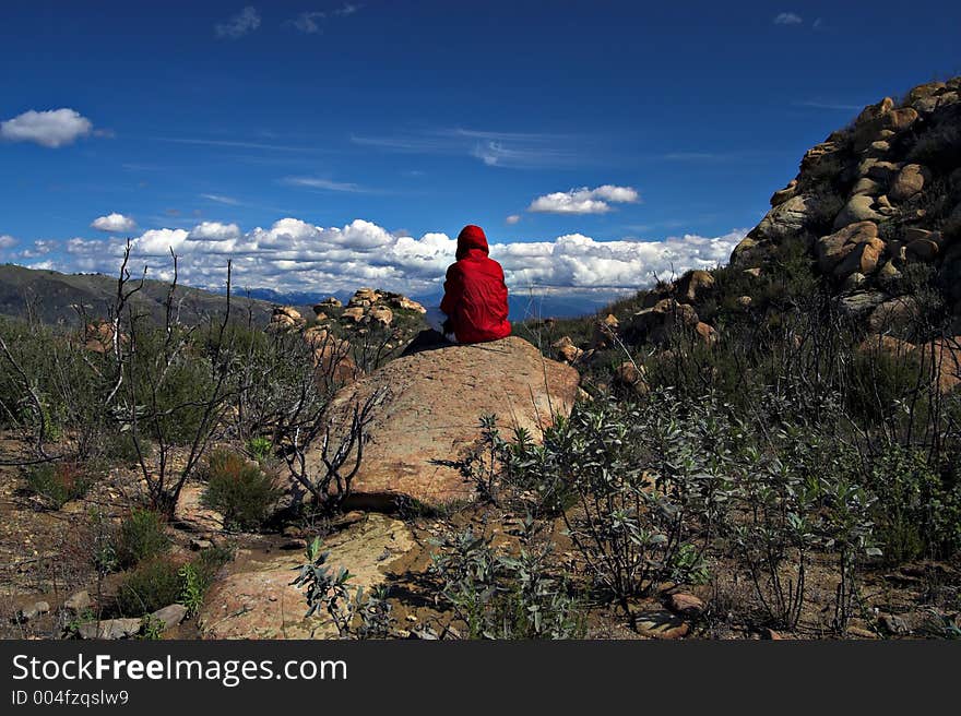 Clouds against red hiker