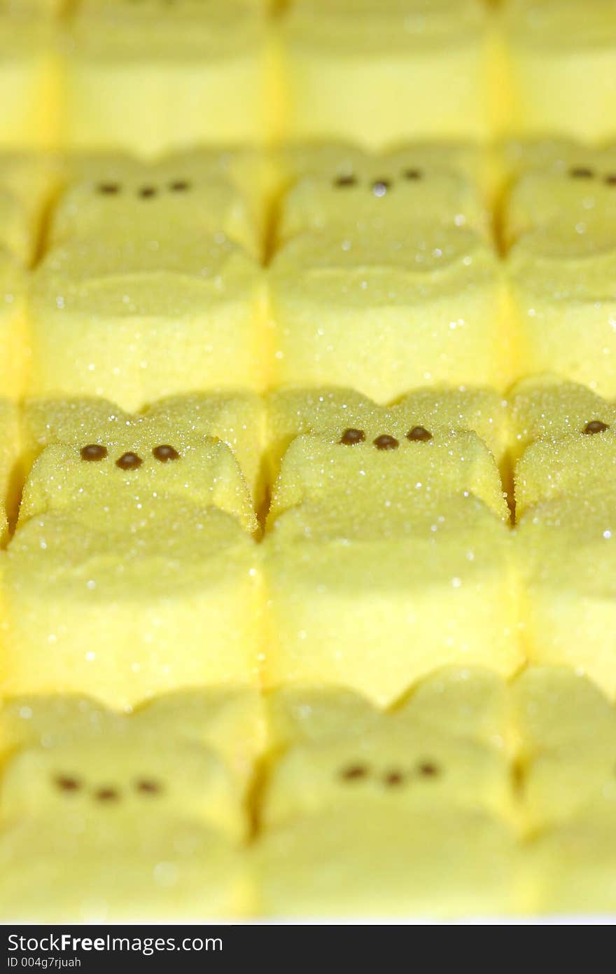 Yellow sugared marshmallow bunnies manufactured in groups. Yellow sugared marshmallow bunnies manufactured in groups