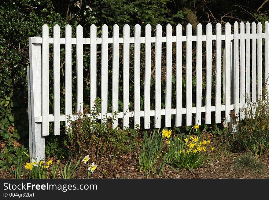 White picket fence and flower bed