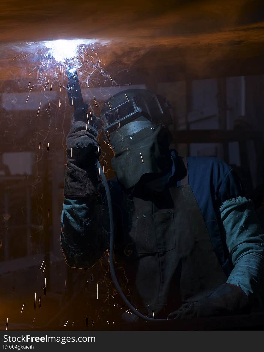 Welder working in smoke trails