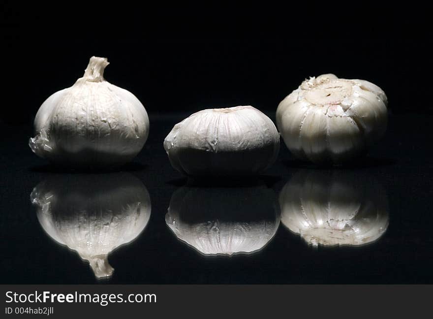 Three fresh white garlics