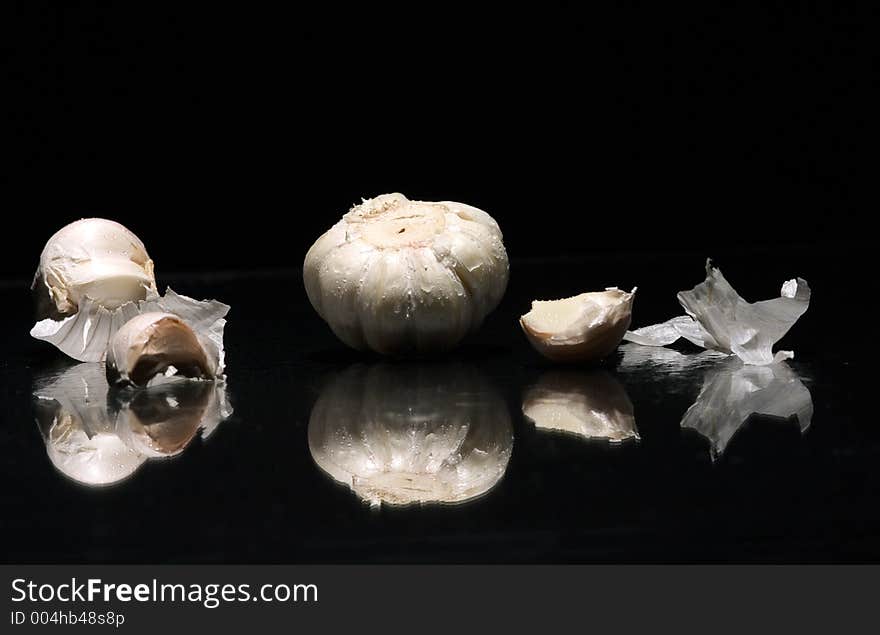 White garlic with drop water on bleck background