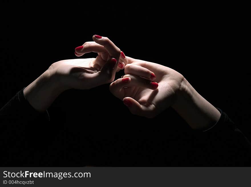 Tie palms with red nails on dark background. Tie palms with red nails on dark background