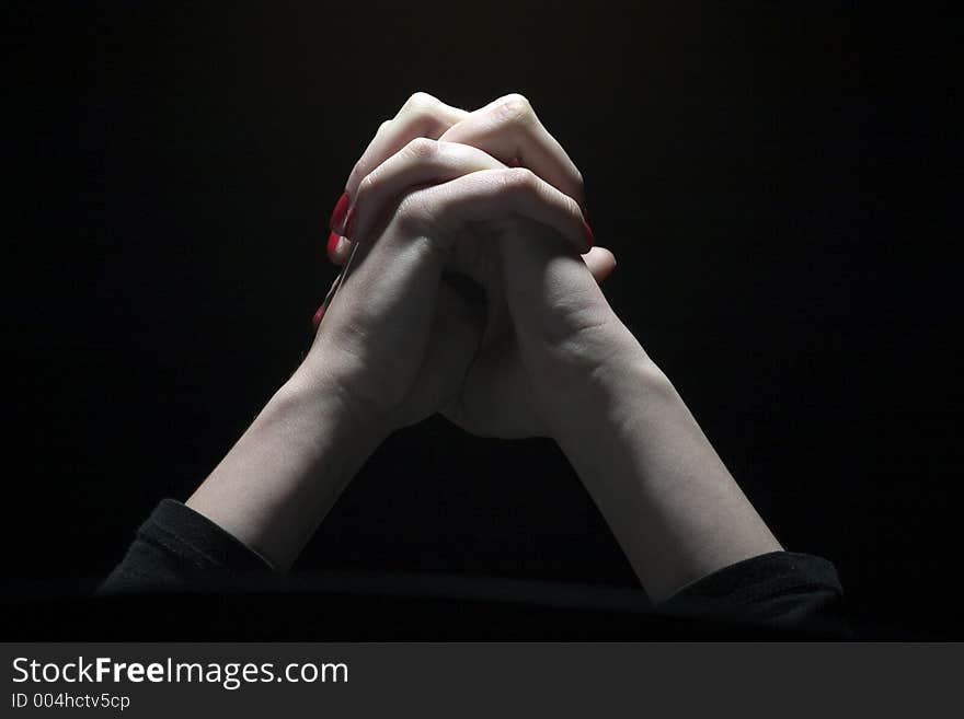 Tie palms with cross fingers in dark background. Tie palms with cross fingers in dark background