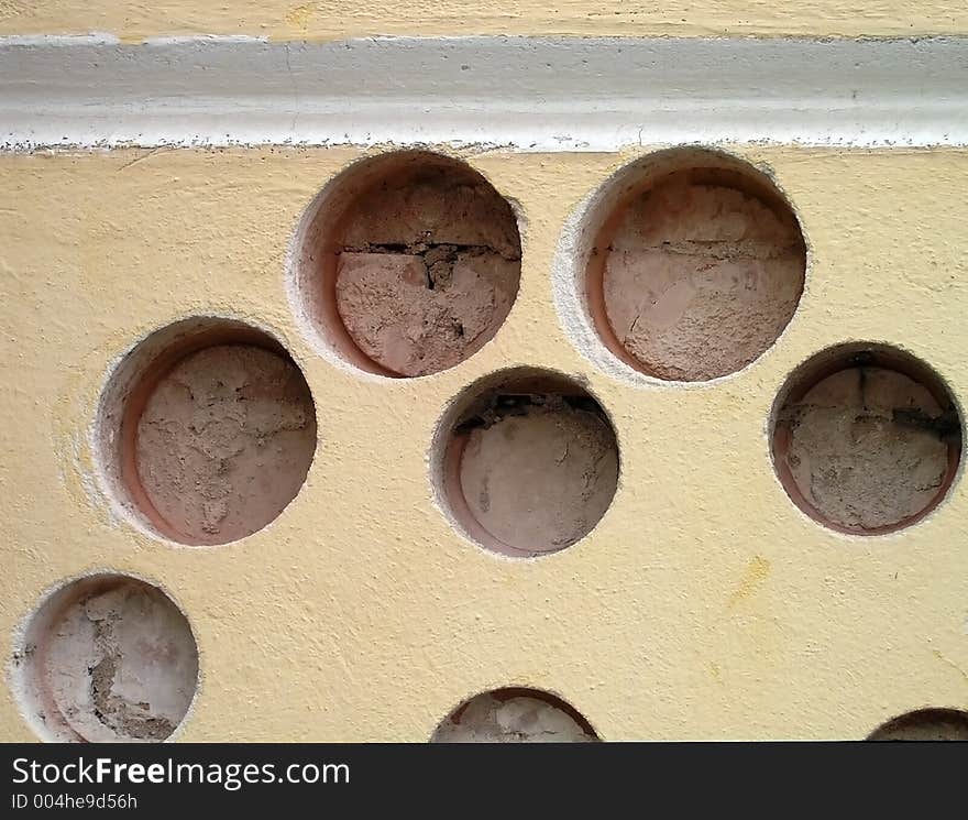 Holes in a wall with white strip