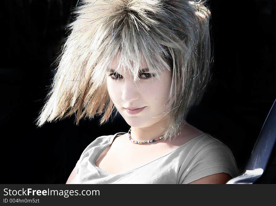 Girl with a wig on a black background. Girl with a wig on a black background