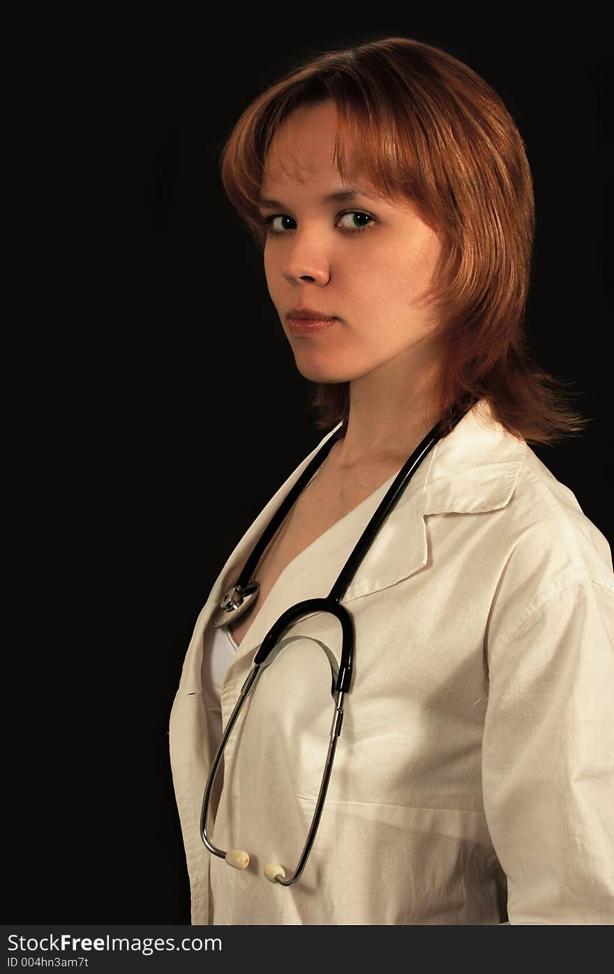 Young woman doctor on black