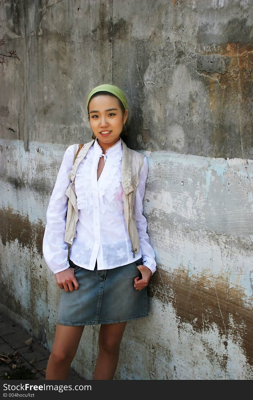 Beautiful Asian woman wearing a white shirt and denim skirt. Beautiful Asian woman wearing a white shirt and denim skirt