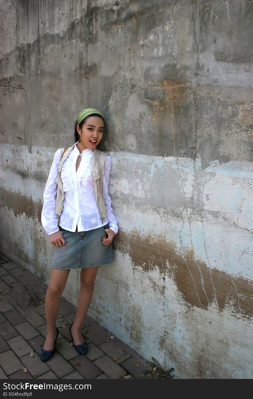 Beautiful Asian woman wearing a white shirt and denim skirt. Beautiful Asian woman wearing a white shirt and denim skirt