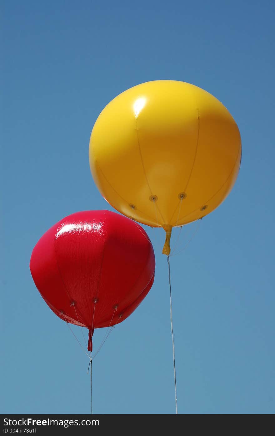 Two coloured balloons flying high