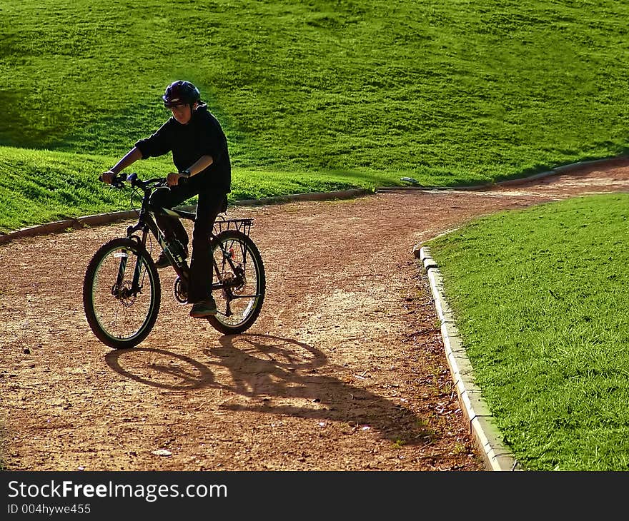 Cyclist on hillside in early summer / late spring