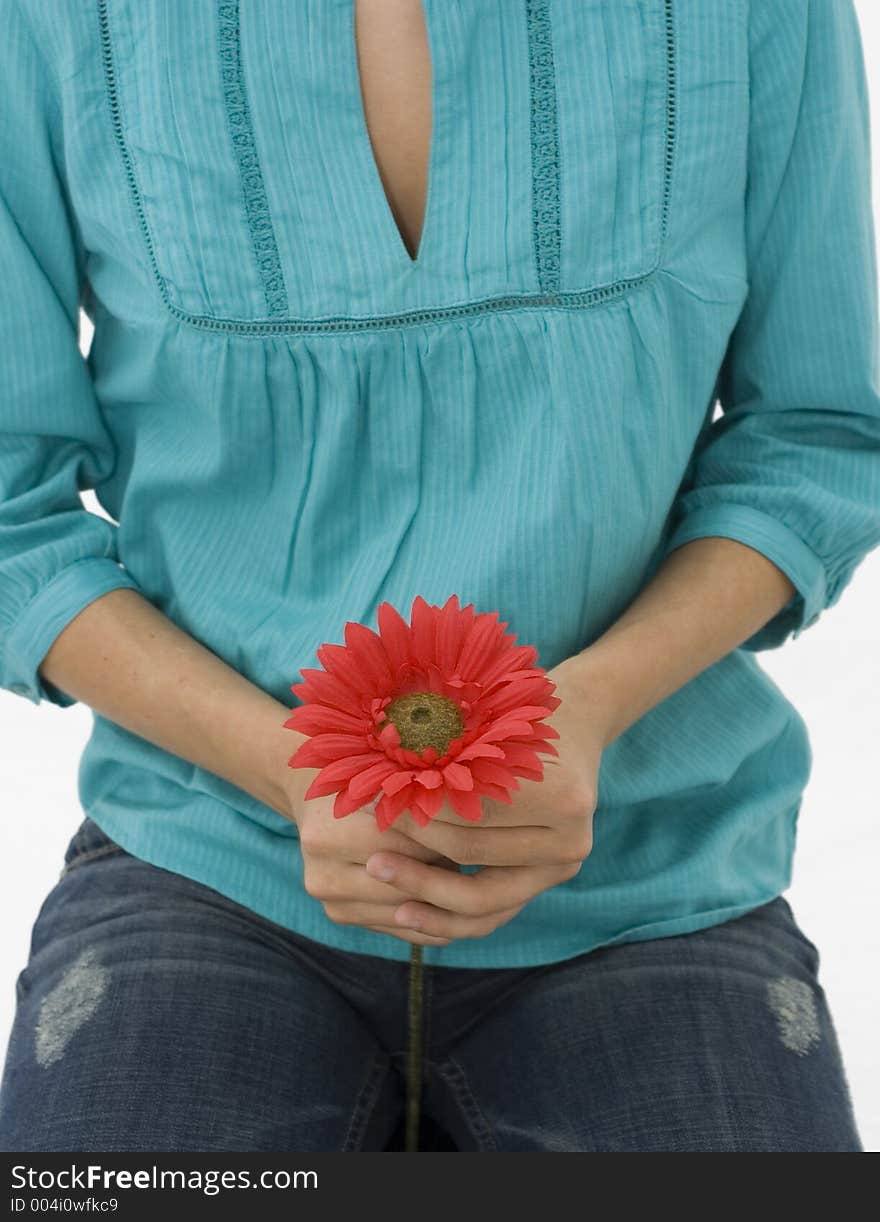 Girl on turquoise shirt holding a red flower. Girl on turquoise shirt holding a red flower