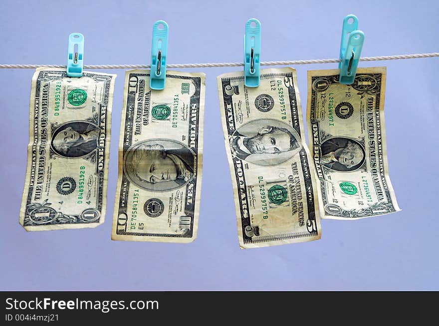 USA or American currency on a laundry (wash) line with blue background. USA or American currency on a laundry (wash) line with blue background