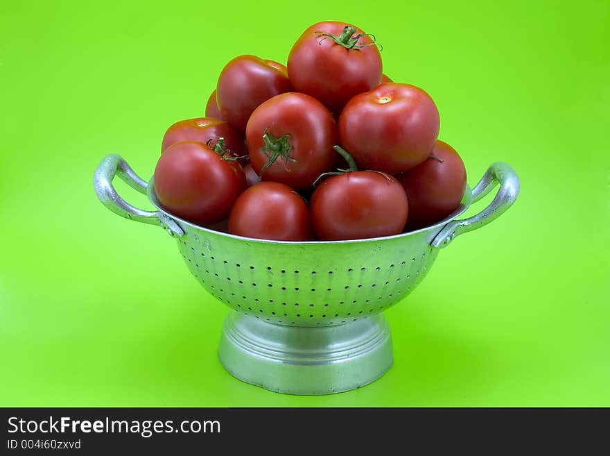 Isolated colander with tomatoes