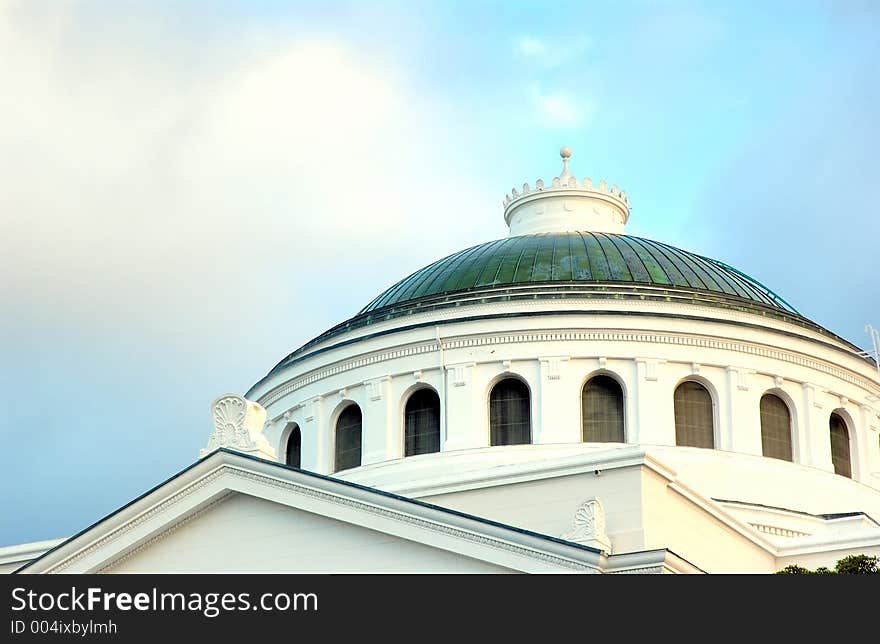 Big white church with green roof