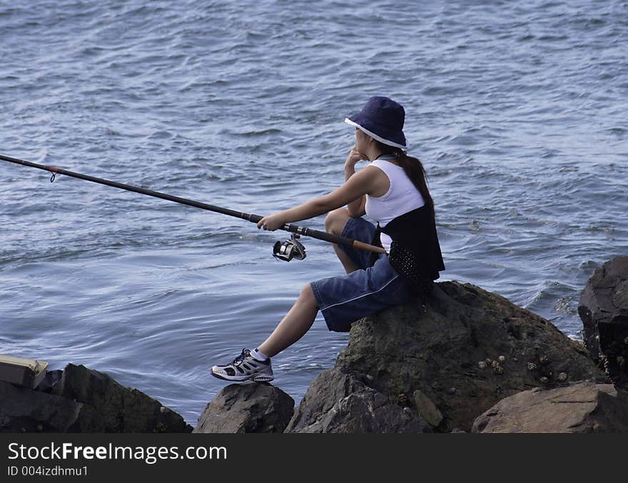 Image of a young lady fishing. Image of a young lady fishing