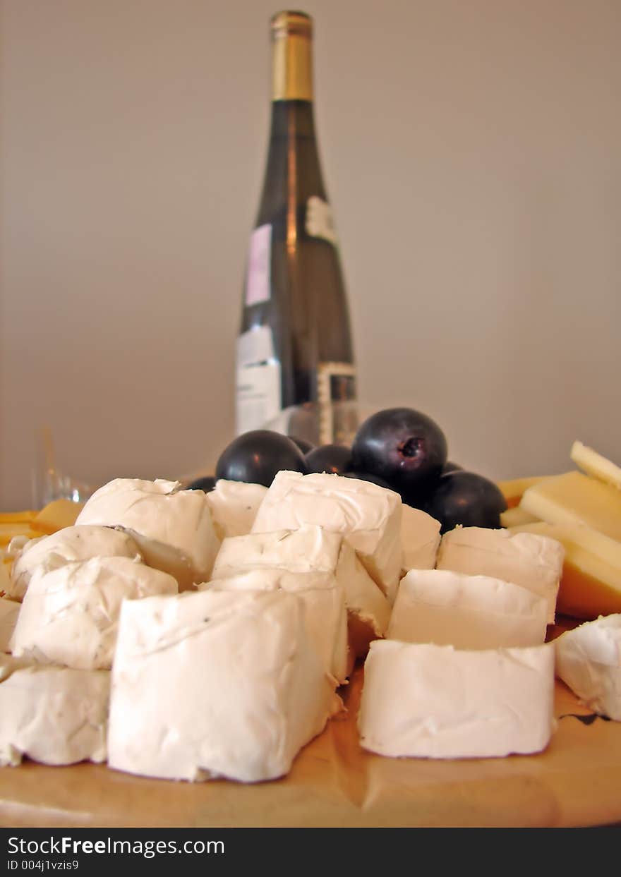 Cheeses plate and bottle of wine