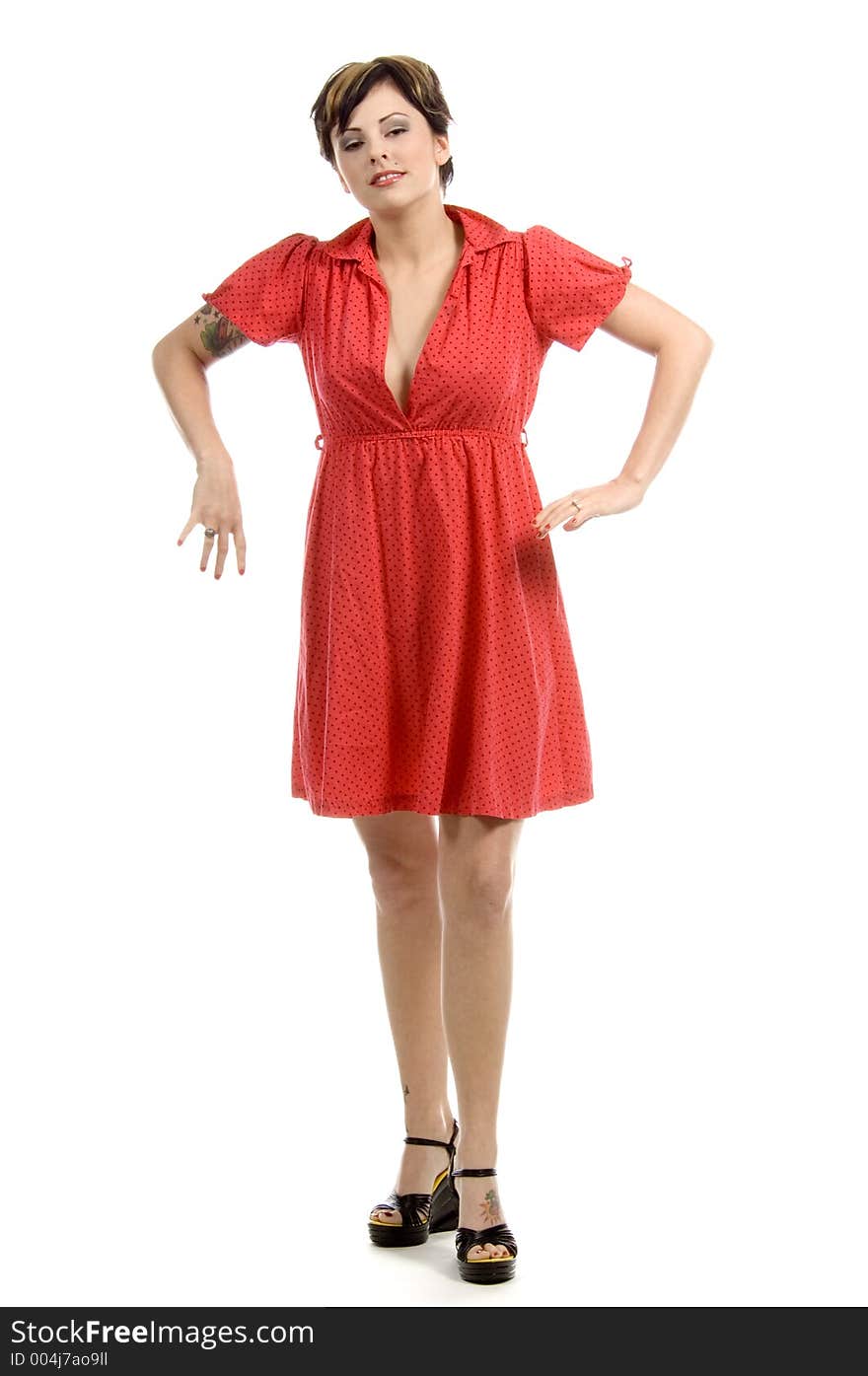 Beautiful young woman with tattoos all over and a new-age punkish hair-style, dances slowly, dressed in a bright red dress, in a cross-culture combination. Beautiful young woman with tattoos all over and a new-age punkish hair-style, dances slowly, dressed in a bright red dress, in a cross-culture combination