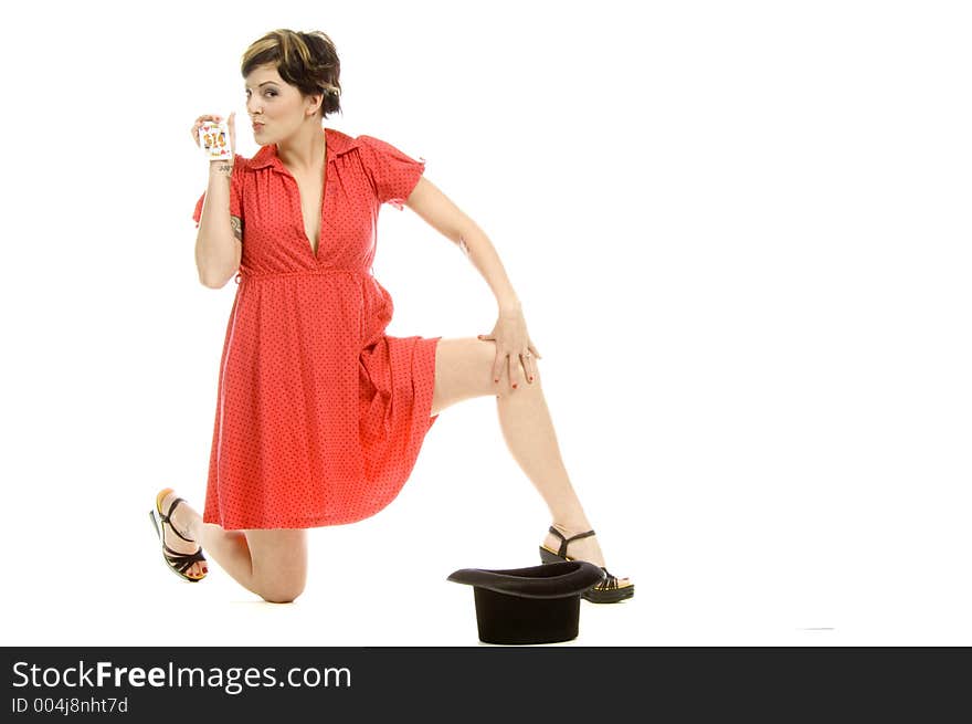 young actress with tattoos, a red girlish dress, poses different postures and expressions for an audition, with playing cards and a big black hat, over a white background. young actress with tattoos, a red girlish dress, poses different postures and expressions for an audition, with playing cards and a big black hat, over a white background