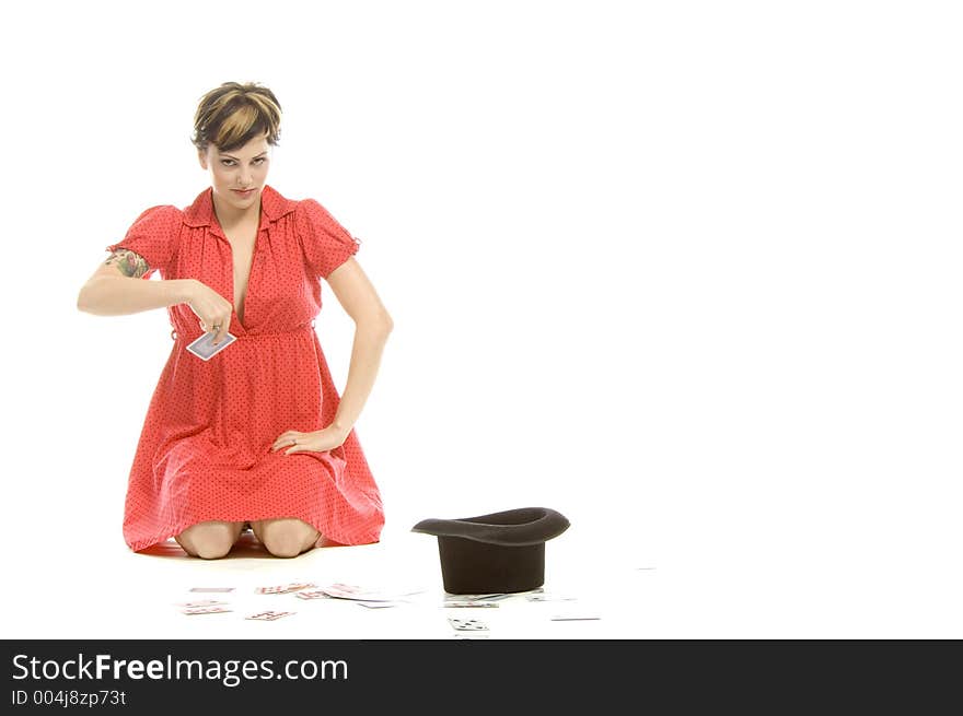 young actress with tattoos, a red girlish dress, poses different postures and expressions for an audition, with playing cards and a big black hat, over a white background. young actress with tattoos, a red girlish dress, poses different postures and expressions for an audition, with playing cards and a big black hat, over a white background