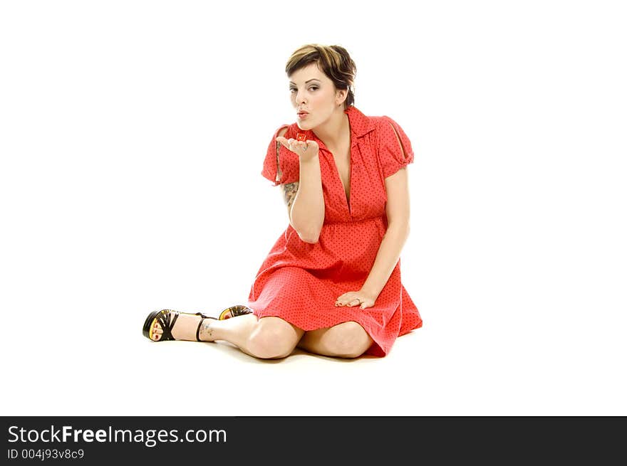 young actress with tattoos, a red girlish dress, poses different postures and expressions for an audition, playing with dices, down on the white floor. young actress with tattoos, a red girlish dress, poses different postures and expressions for an audition, playing with dices, down on the white floor