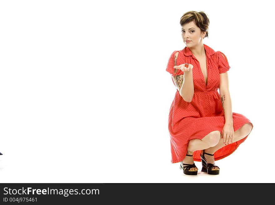 young actress with tattoos, a red girlish dress, poses different postures and expressions for an audition, playing with dices, down on the white floor. young actress with tattoos, a red girlish dress, poses different postures and expressions for an audition, playing with dices, down on the white floor