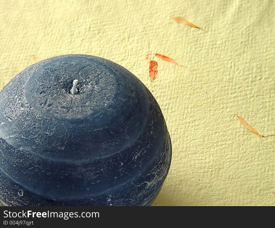 A candle on textured letter paper