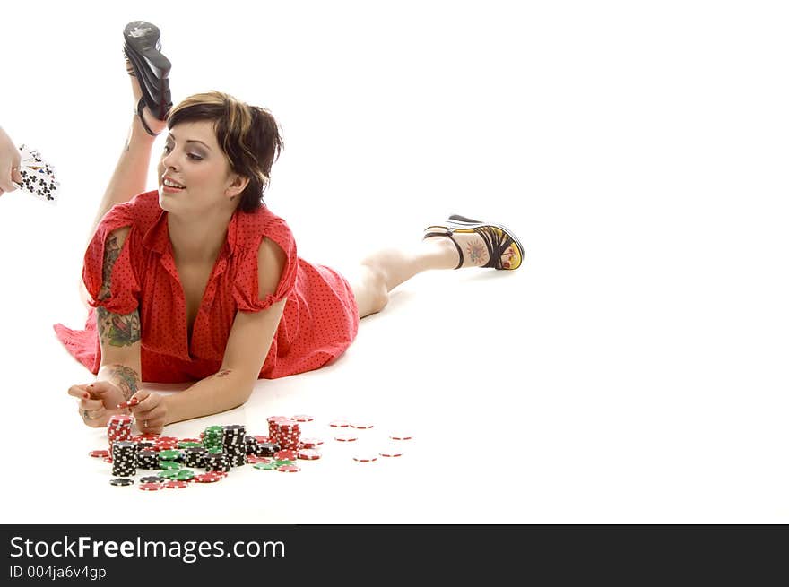 young actress with tattoos, a red girlish dress, poses different postures and expressions for an audition, with tokens in front of her, down on the white floor, while someone hands her some cards. young actress with tattoos, a red girlish dress, poses different postures and expressions for an audition, with tokens in front of her, down on the white floor, while someone hands her some cards