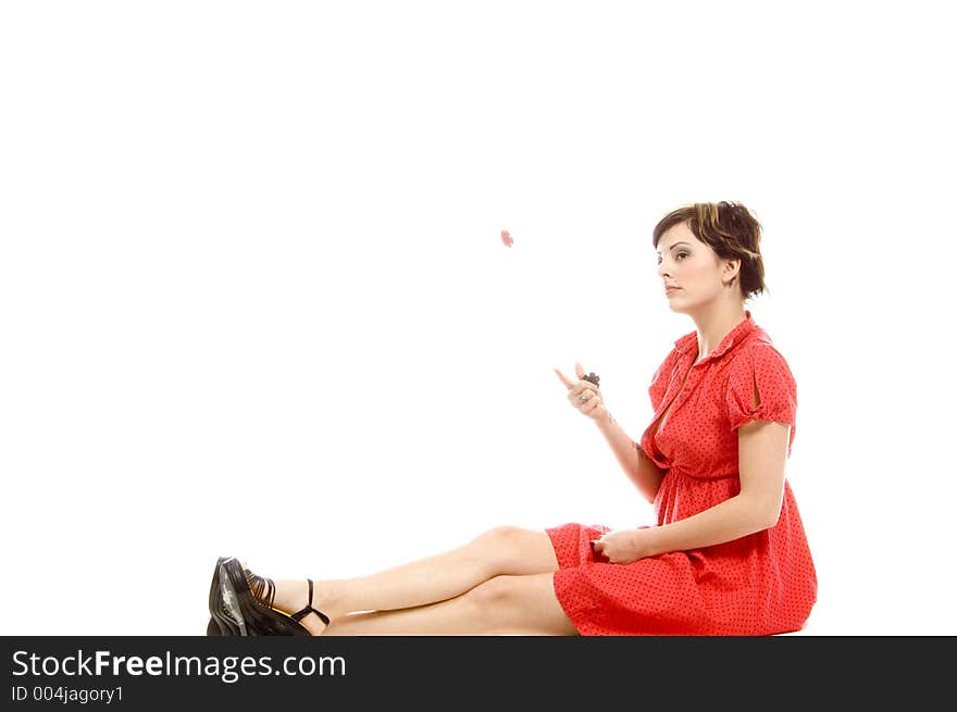 young actress with tattoos, a red girlish dress, poses different postures and expressions for an audition, throwing dices, over a white background. young actress with tattoos, a red girlish dress, poses different postures and expressions for an audition, throwing dices, over a white background