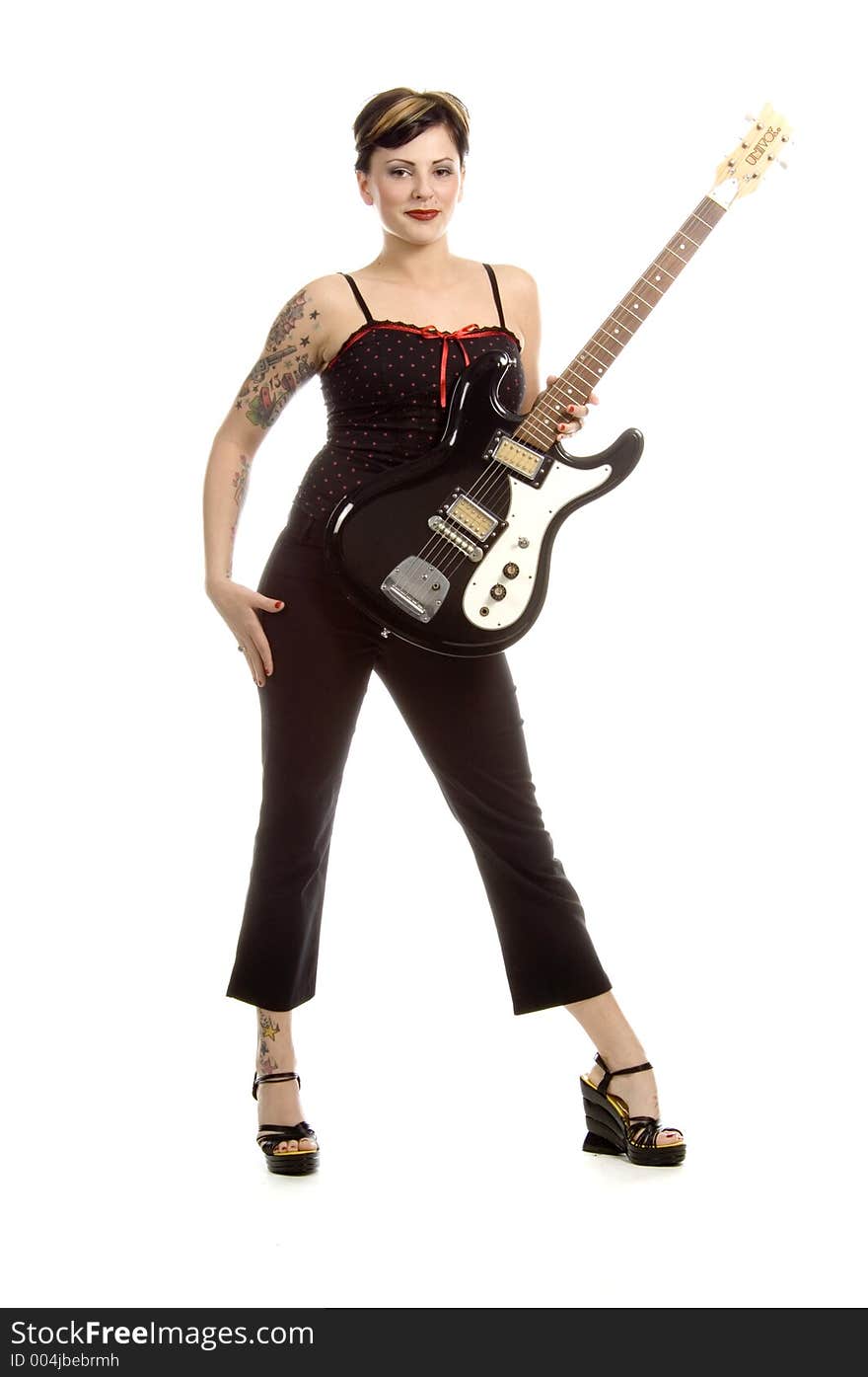 Woman in her thirties playing electric guitar. Woman in her thirties playing electric guitar