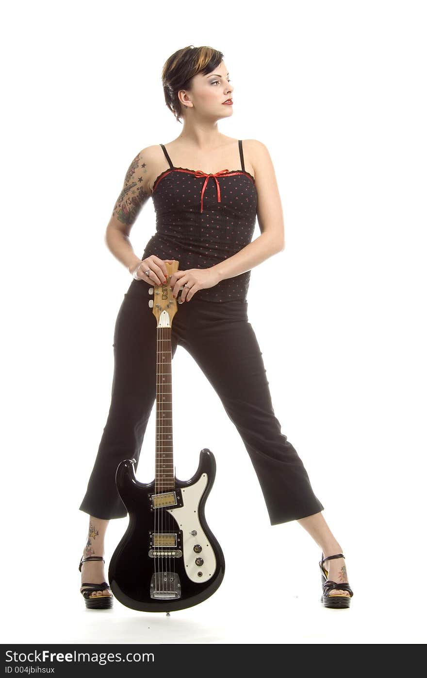 Woman in her thirties playing music on electric guitar. Woman in her thirties playing music on electric guitar