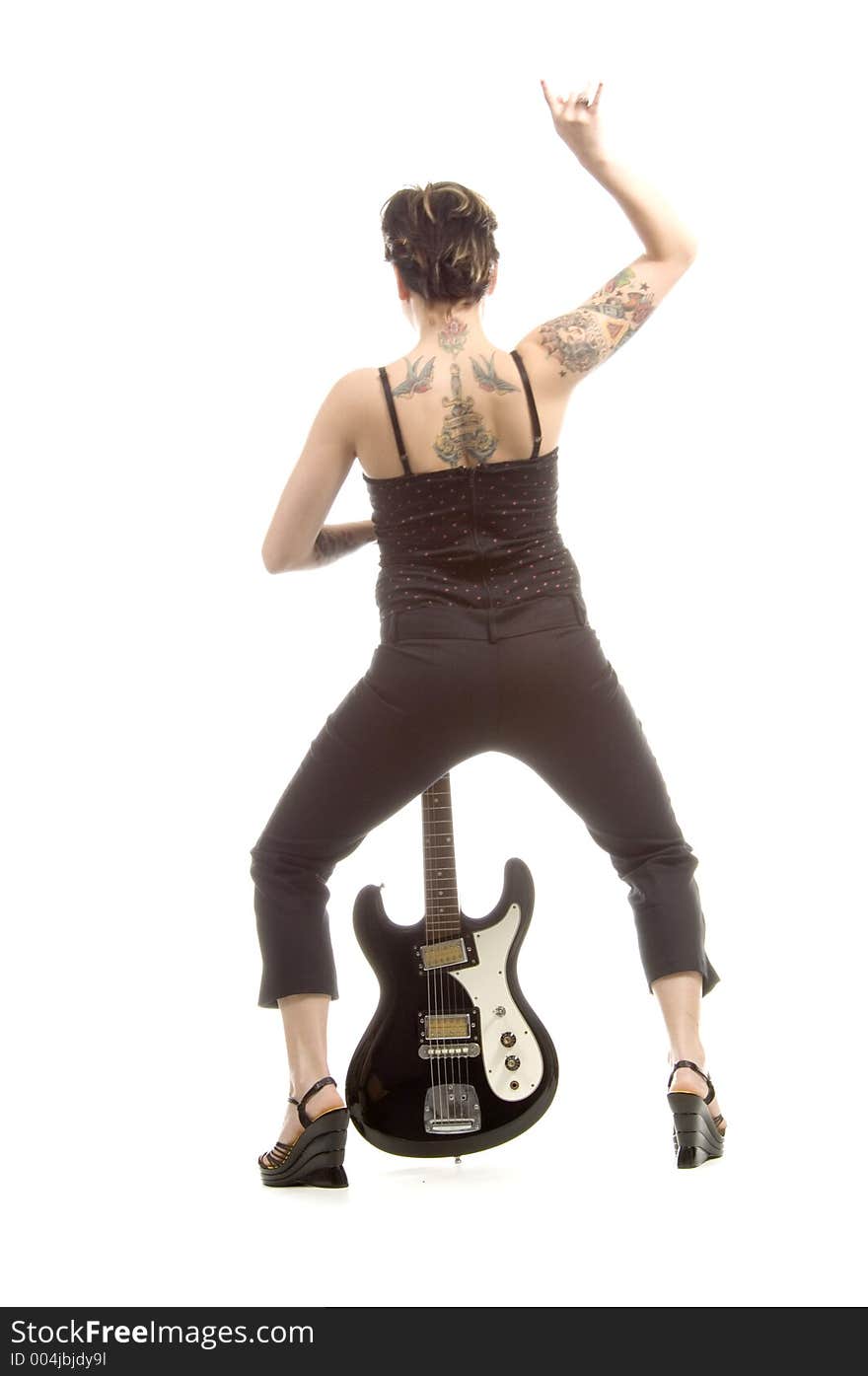 Woman in her thirties playing music on electric guitar. Woman in her thirties playing music on electric guitar