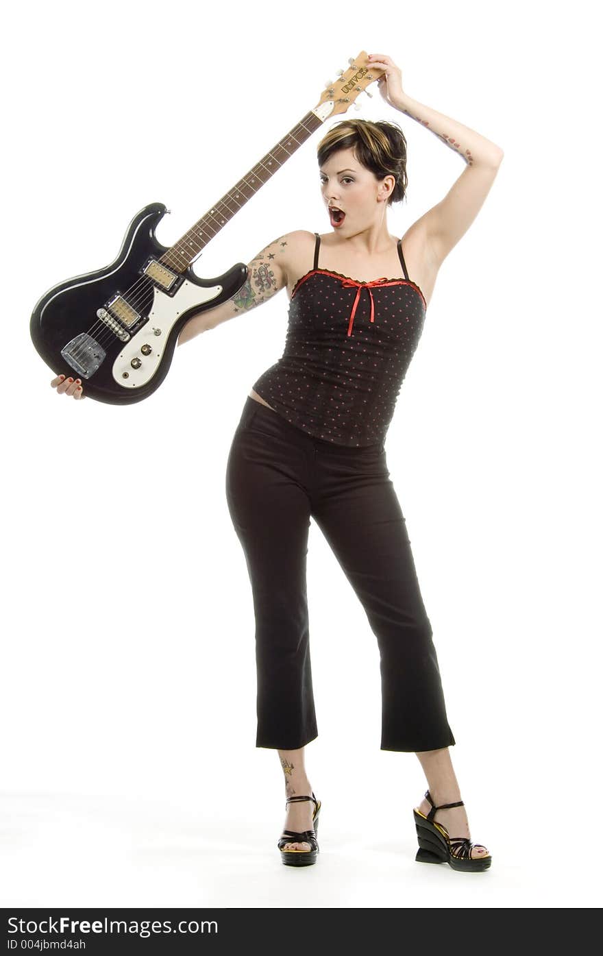 Woman in her thirties playing music on electric guitar. Woman in her thirties playing music on electric guitar